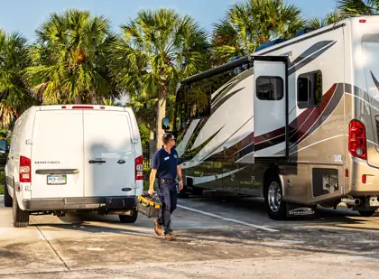 RV Renew technician beside a motorhome and service van in Central Florida